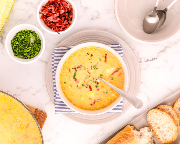Corn Chowder in a bowl with corn cobs