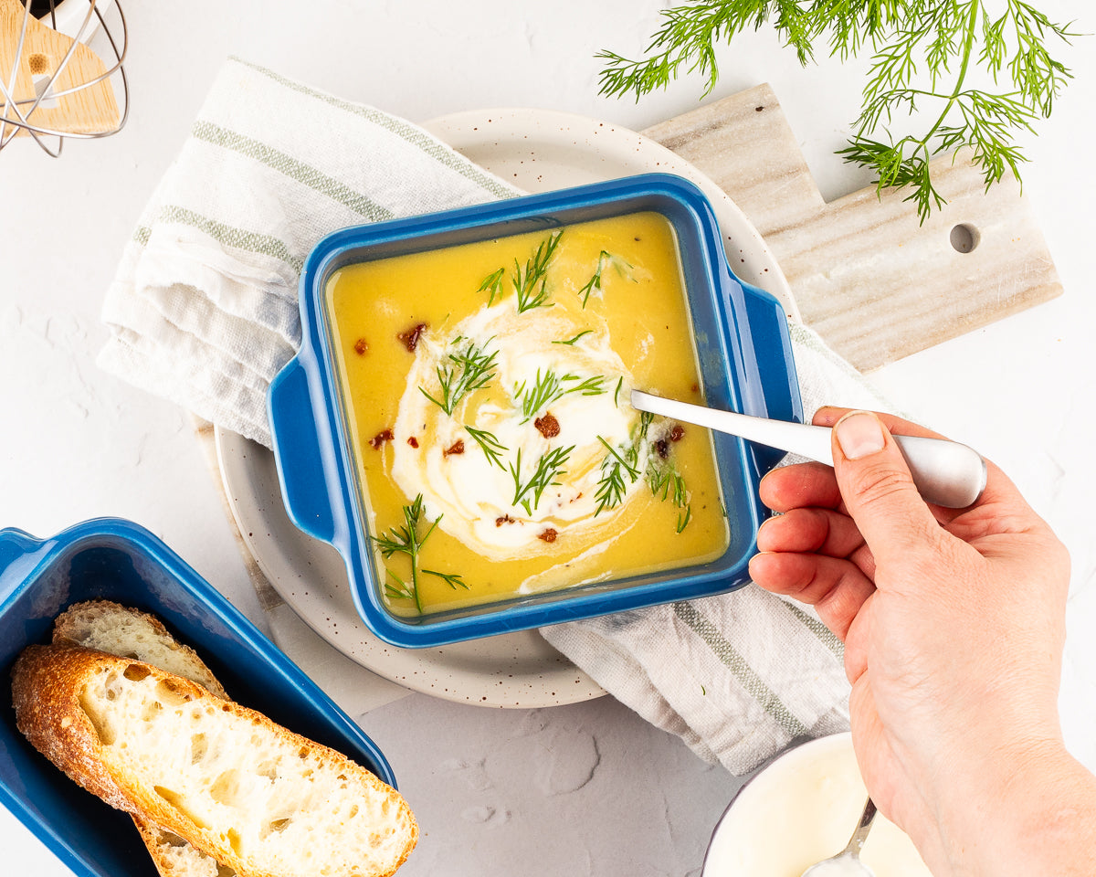 creamy potato leek soup in a Souper Cubes stoneware baking dish with sourdough