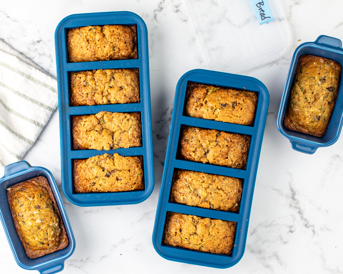 The Best Chocolate Chip Zucchini Bread (Freezer-Friendly Recipe) in Souper Cubes silicone trays and ceramic baking dishes
