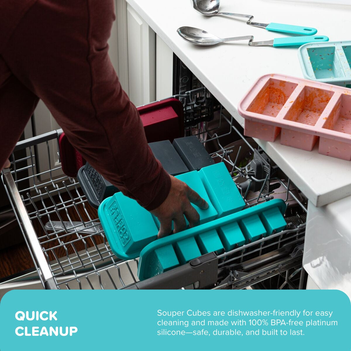 Person placing an aqua Souper Cubes tray into an open dishwasher