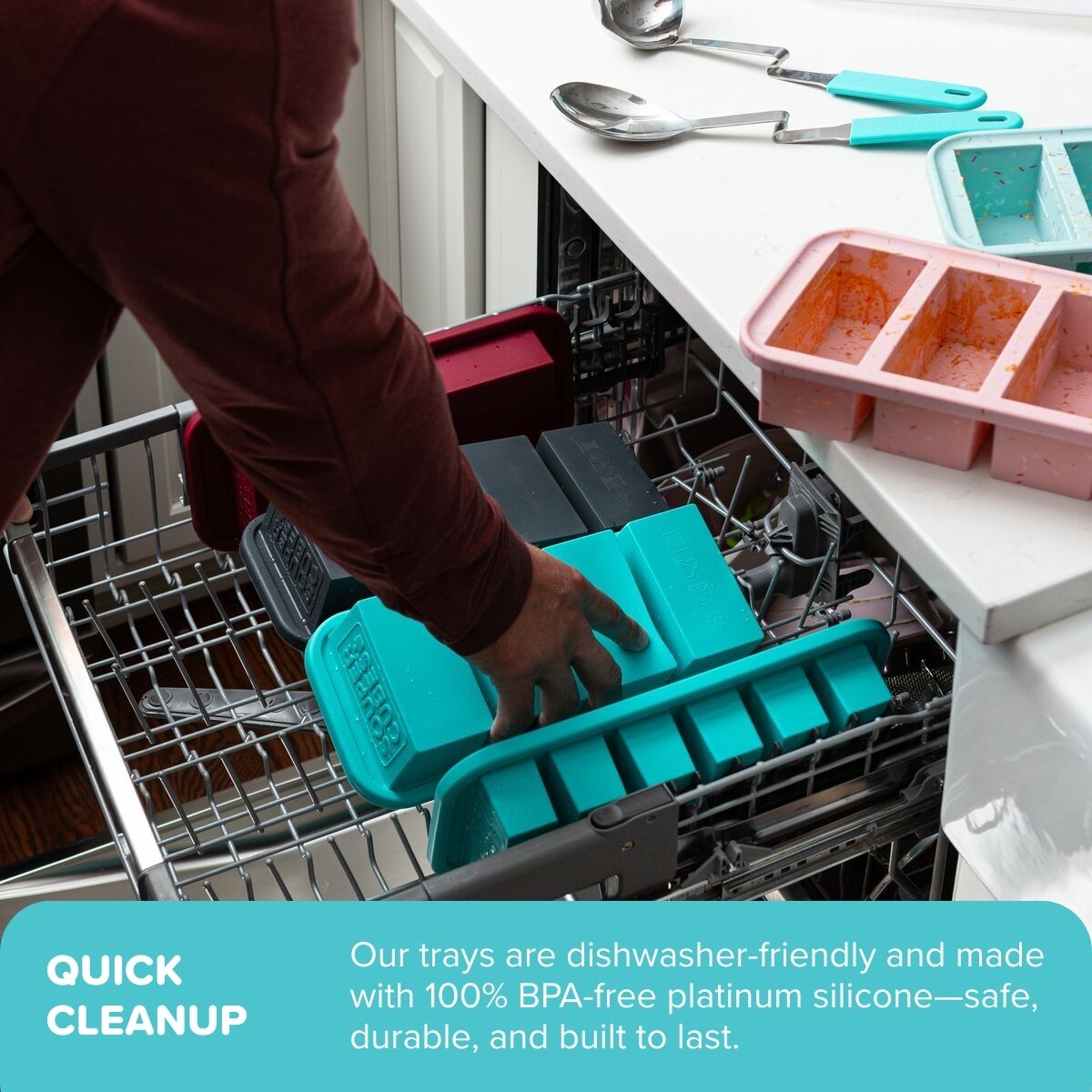 Person placing an aqua Souper Cubes tray into an open dishwasher