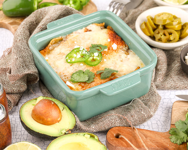 Enchilada Casserole in Souper Cubes Baking Dish with topping like avocado, cotija cheese and jalapeno around