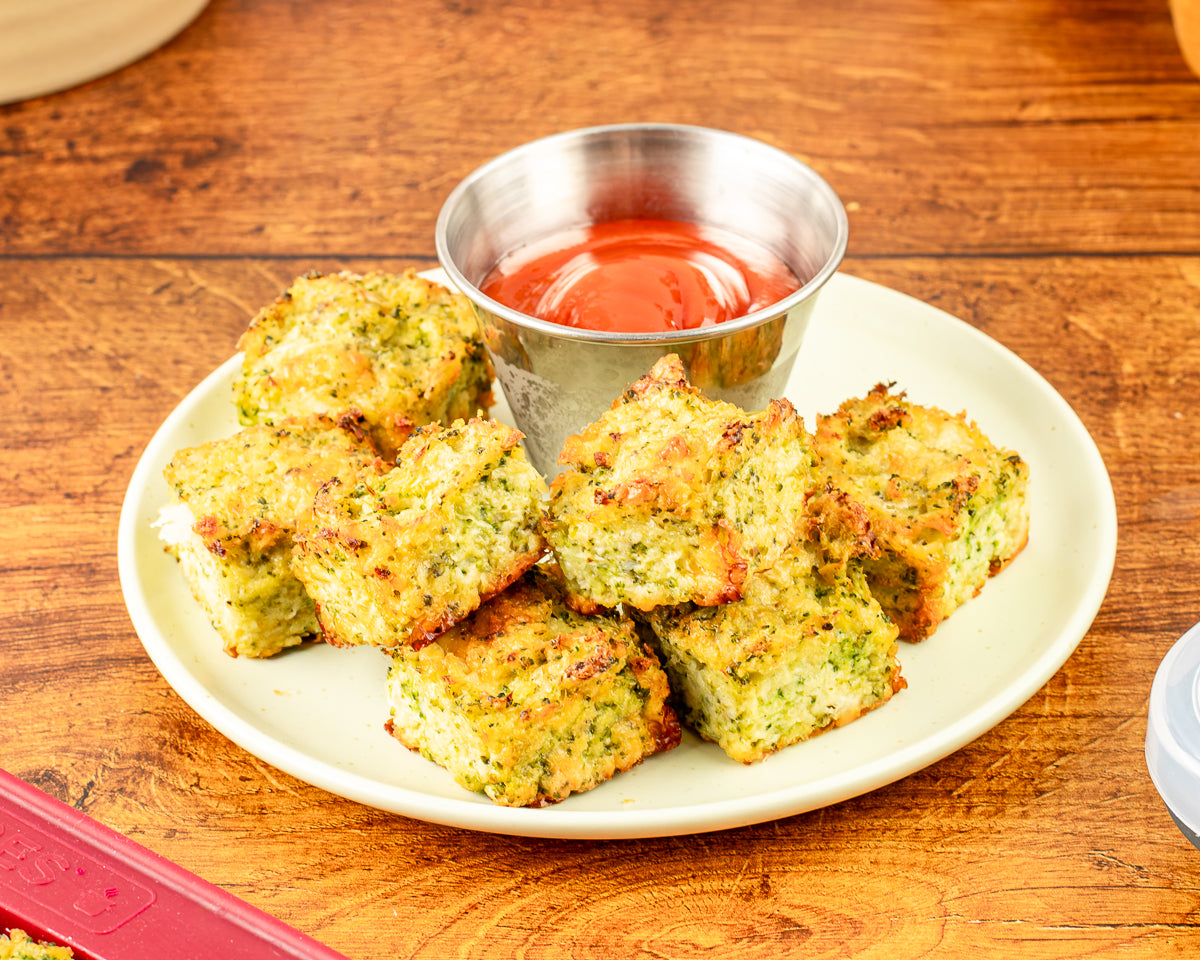 broccoli cheddar tot baked on a plate with ketchup