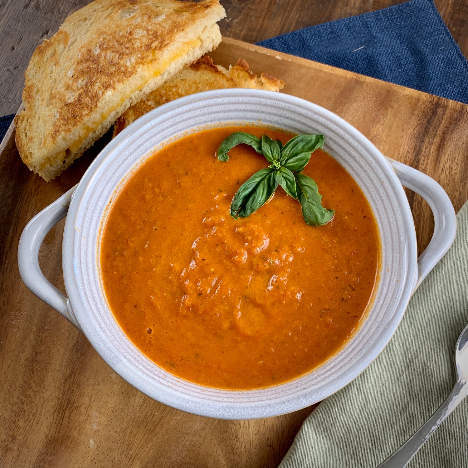 bowl of creamy basil soup with grilled cheese