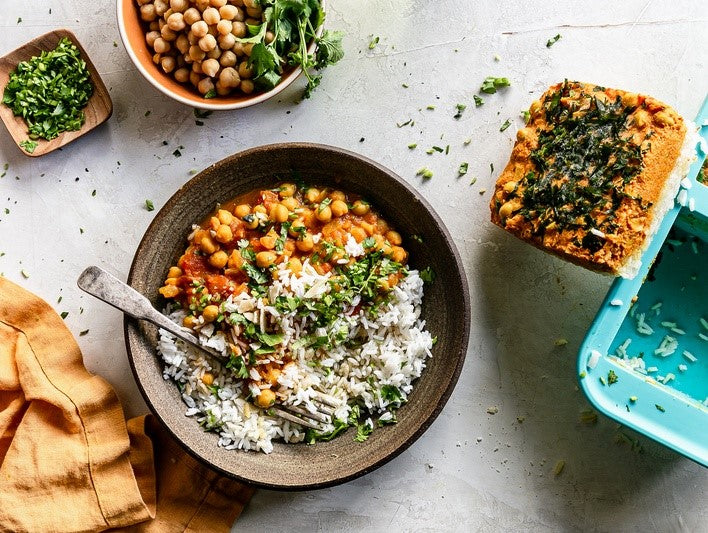 Rice bowl in a brown dish with a 2-cup Souper Cubes tray on the right hand side. 
